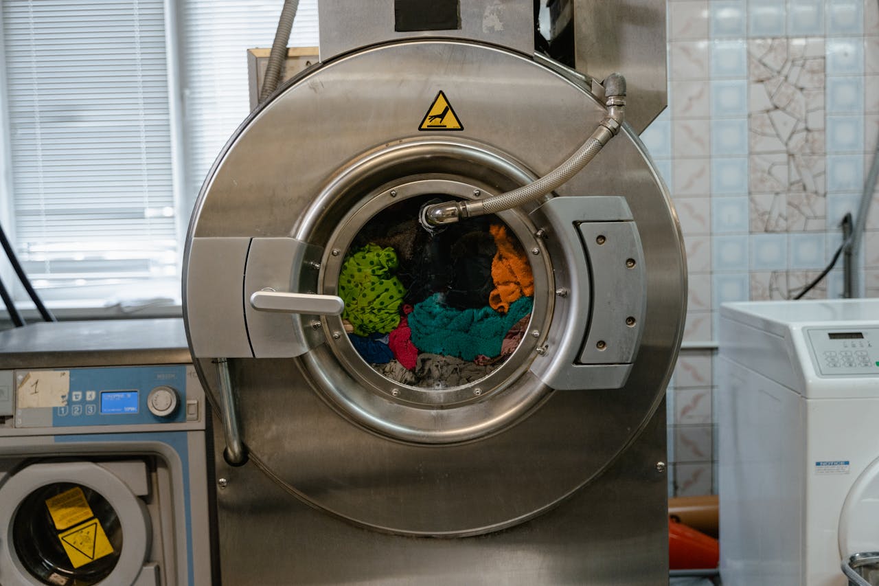 hero-img A close-up of an industrial washing machine operating in a laundry facility.