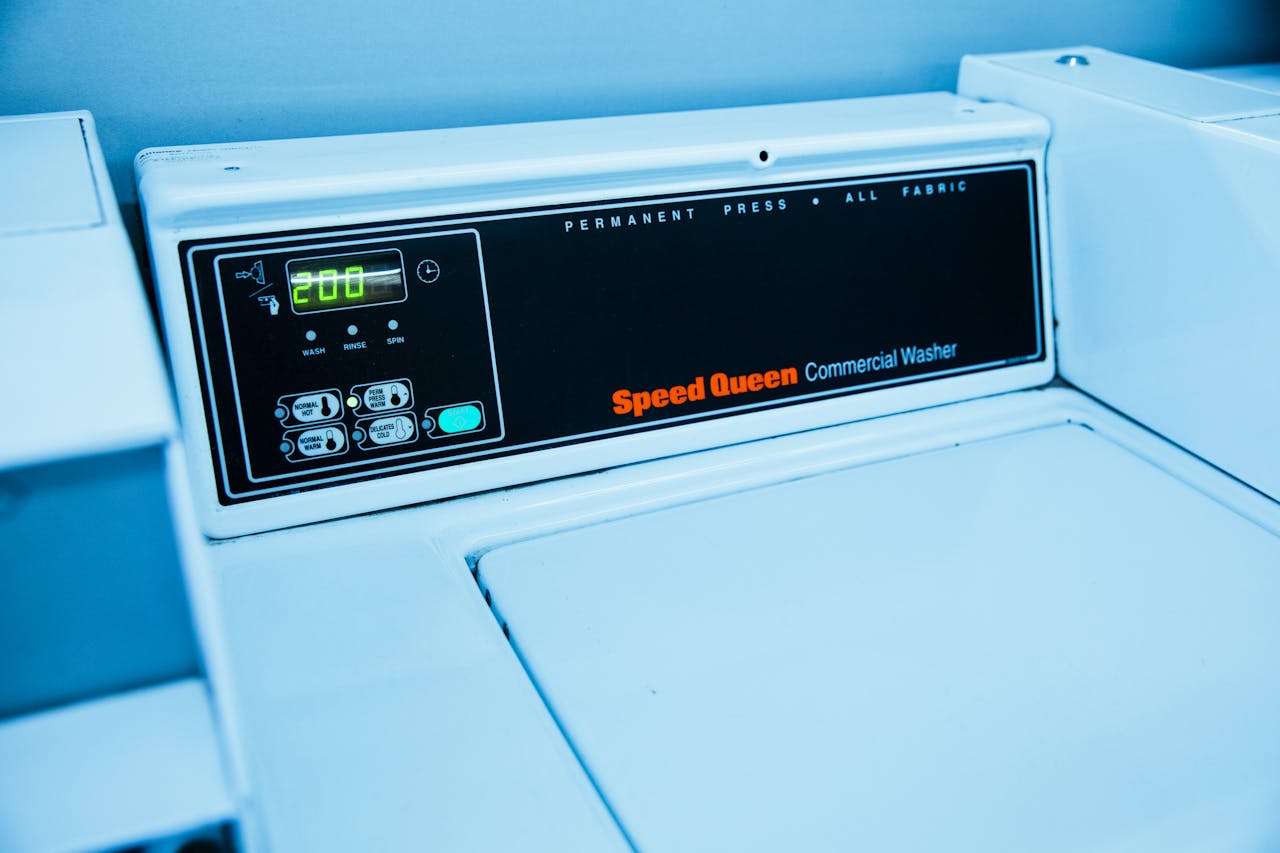 about-01 Close-up of Speed Queen commercial washing machine controls in a laundromat setting.
